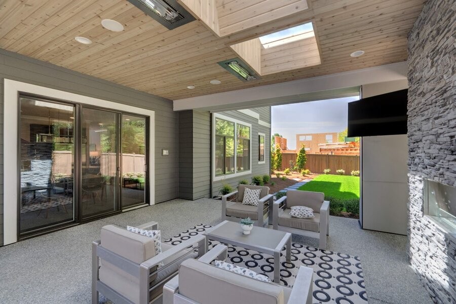 An outdoor patio space featuring a mounted outdoor TV