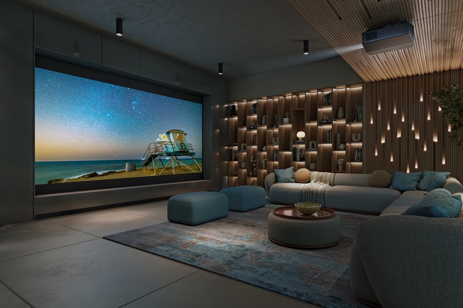 Stylish home theater with a large projector screen, cozy seating, ambient shelf lighting, and a modern ceiling-mounted Sony projector.