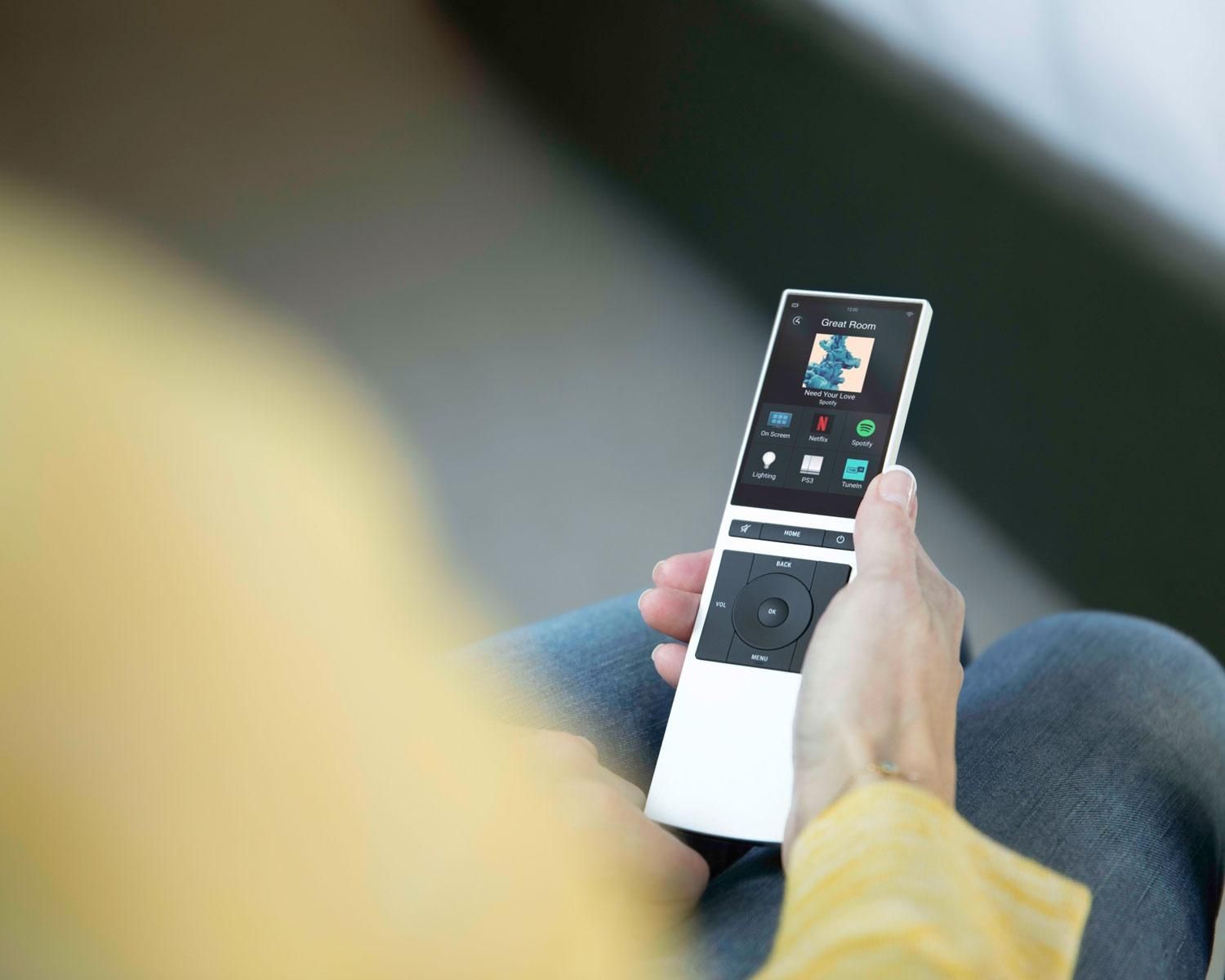 Woman holding silver neeo remote