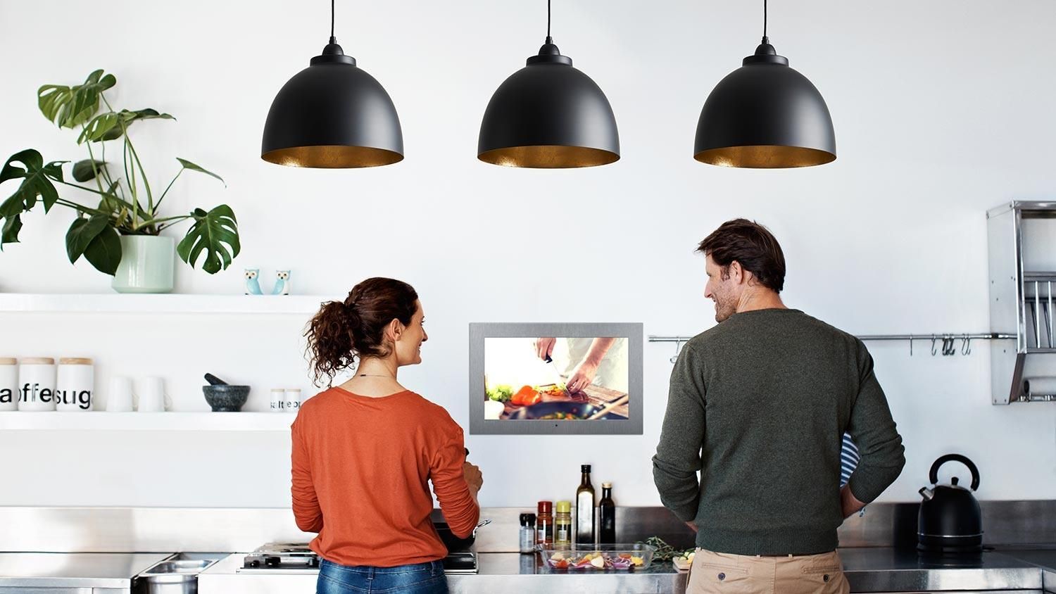 Seura Hydra Waterproof Mirror TV in a kitchen where a couple is cooking